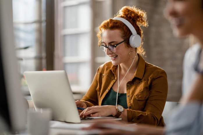 A girl wearing a headphones and practicing for listening