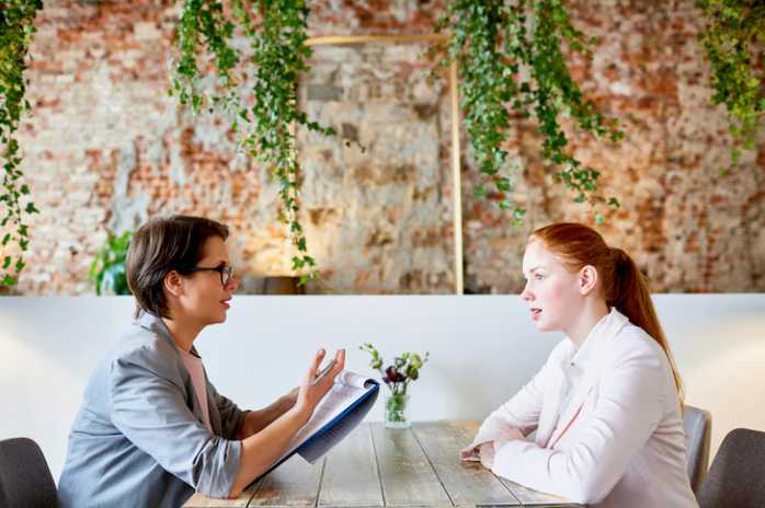 Two people talking and taking the IELTS speaking test