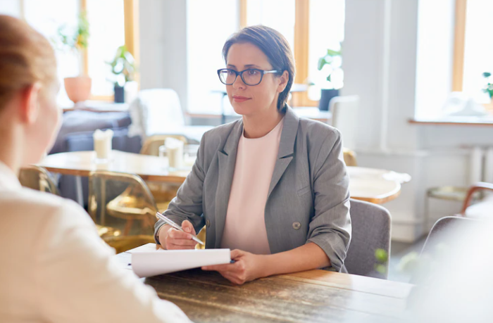 2 women who are taking a speaking exam