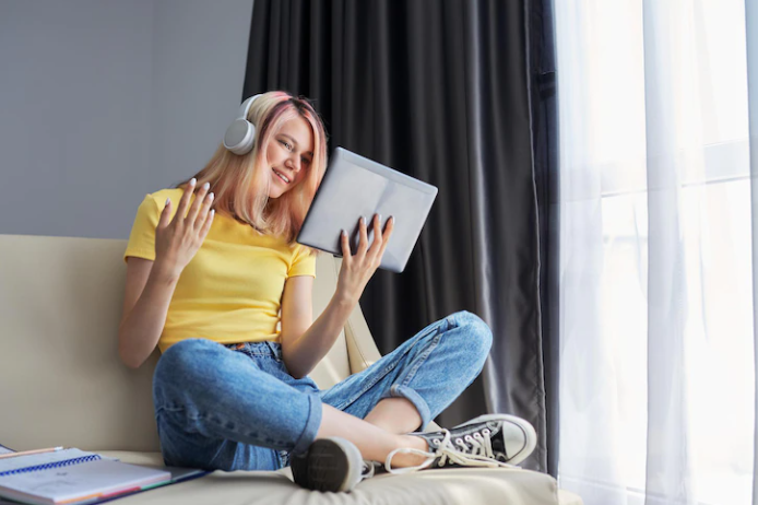 A student listening to a podcast and rehearsing