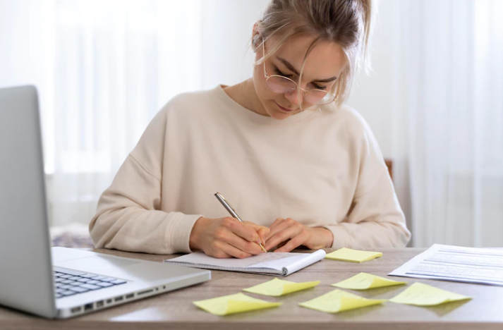 A girl practicing writing and taking notes