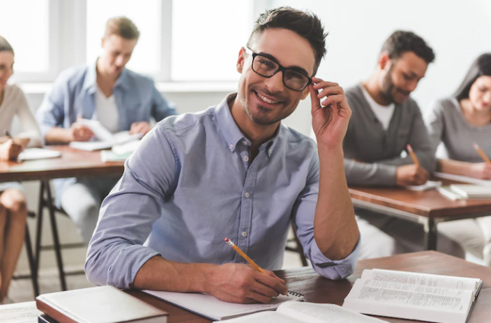 A man taking a writing test and happy with his success