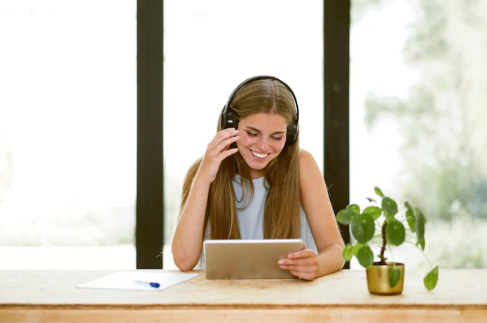 A girl listening to a podcast and rehearsing