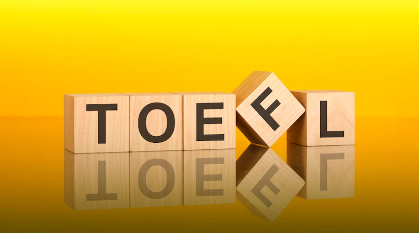 A photo with an orange background in which the word TOEFL is written