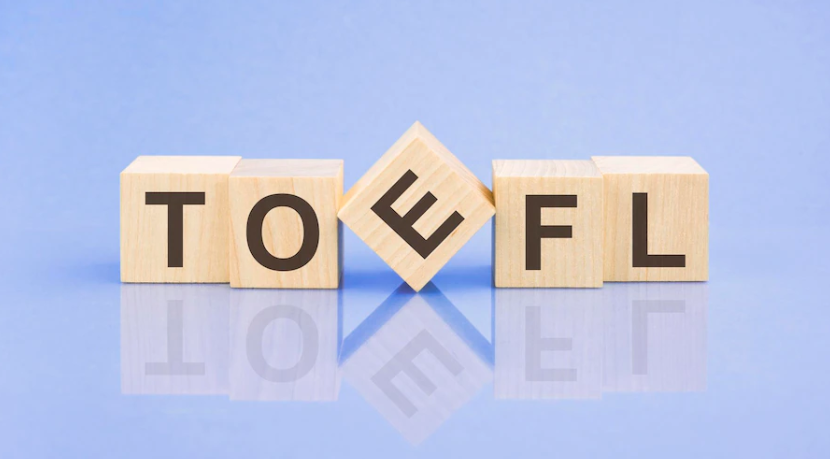 A picture in which the word TOEFL is written on wood