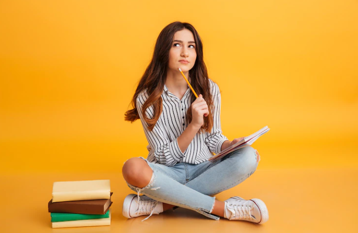 A girl who is thinking and reading a book