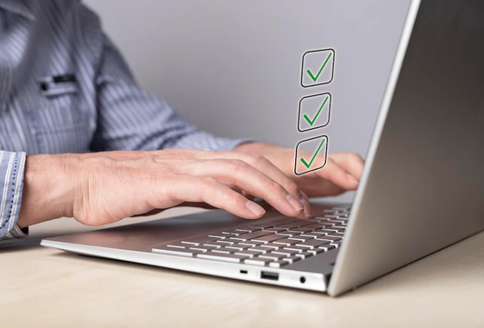 A man is typing on a laptop