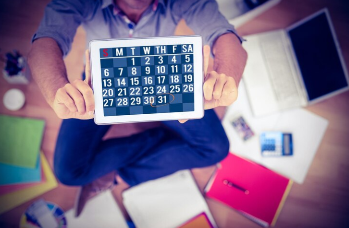 The man holding a calendar and next to it is an office and a book