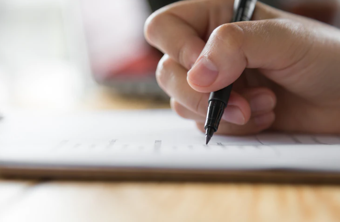 Someone is solving test questions with a pen