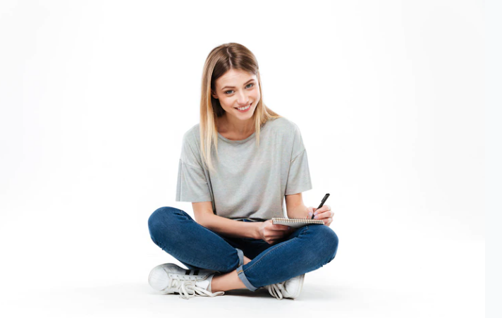 A beautiful girl is writing and laughing