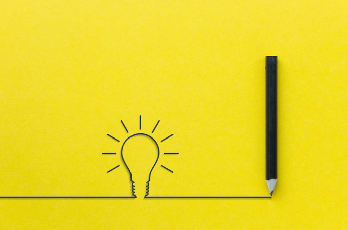 A yellow background image with a pencil and a light