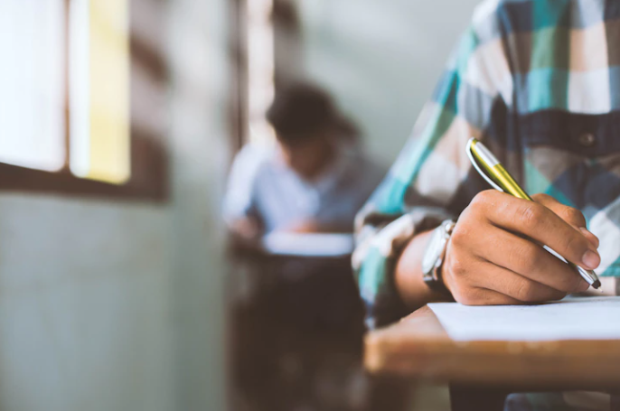 A boy is testing with a pen