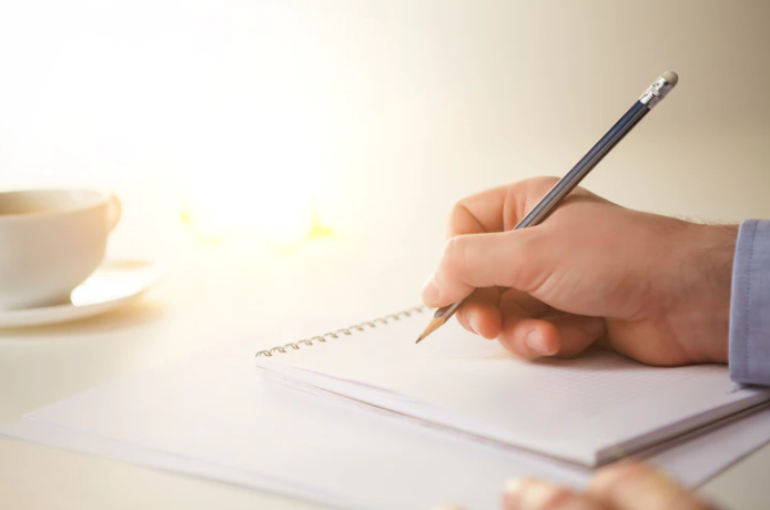 A boy is writing with a pencil