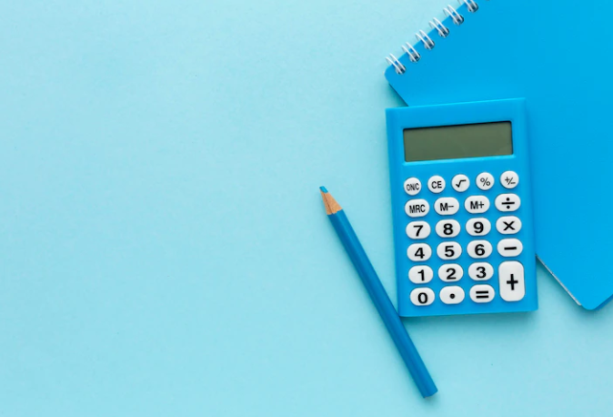 Notebook, pencil and calculator in blue